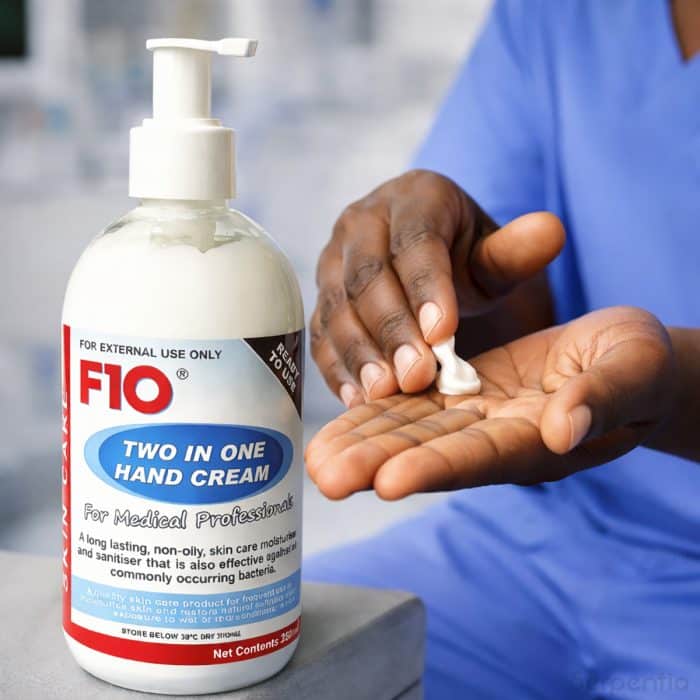 F10 two in one hand cream being dispensed onto hands in a medical environment